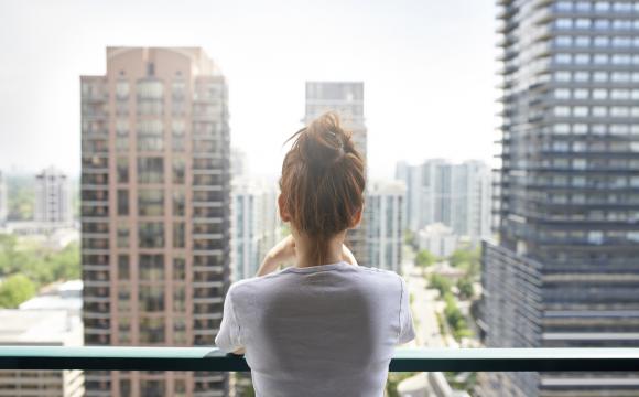 lady overlooking high rise building